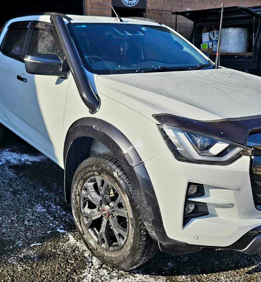 wet white pickup truck parked on a pavement