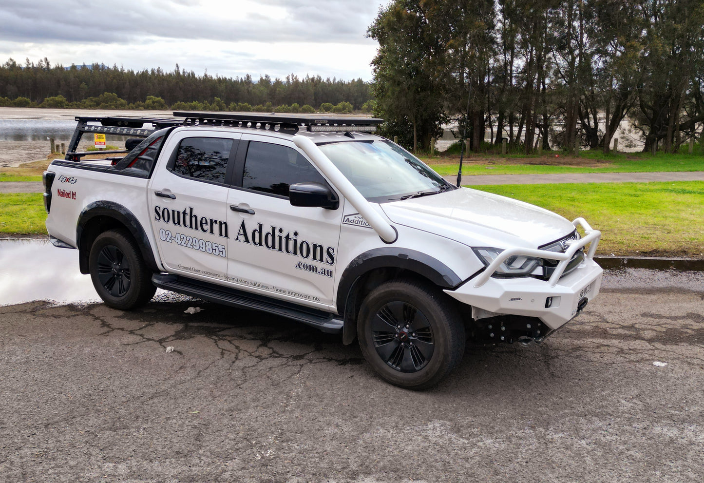Show thumbnail preview
White pickup truck parked on a paved area near grass and trees.