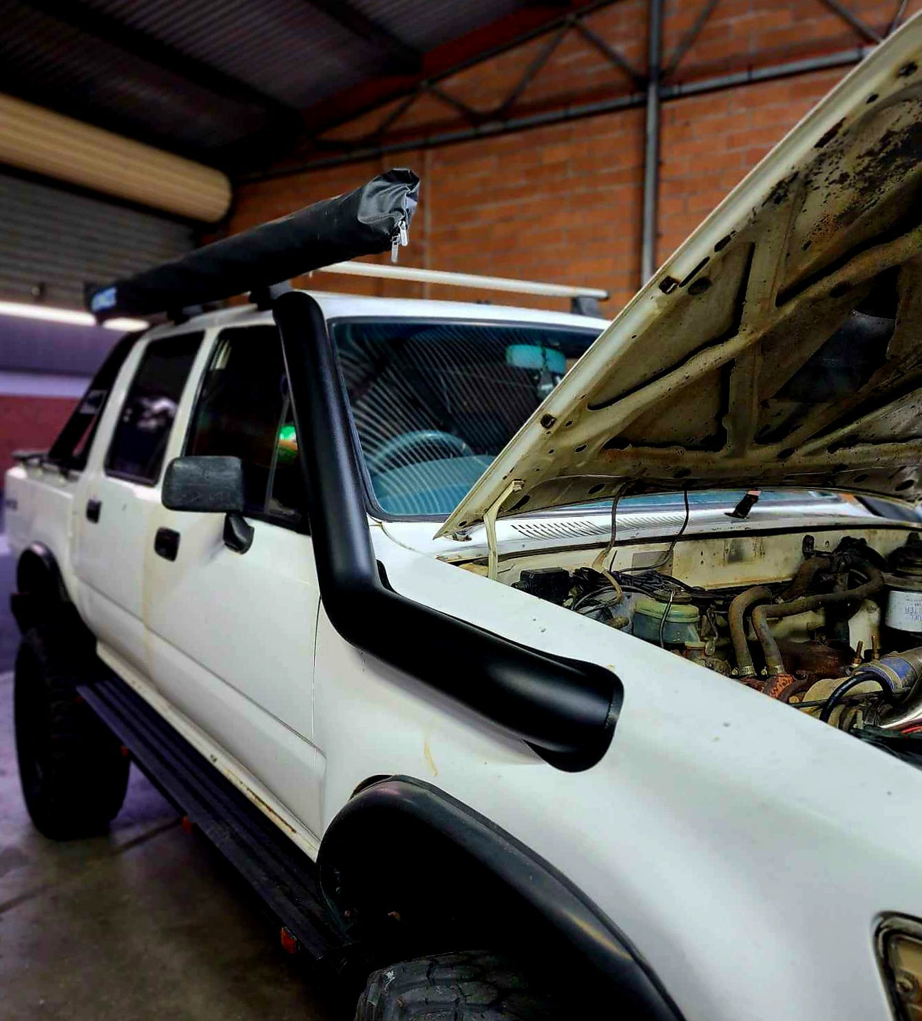 white pickup truck with open hood