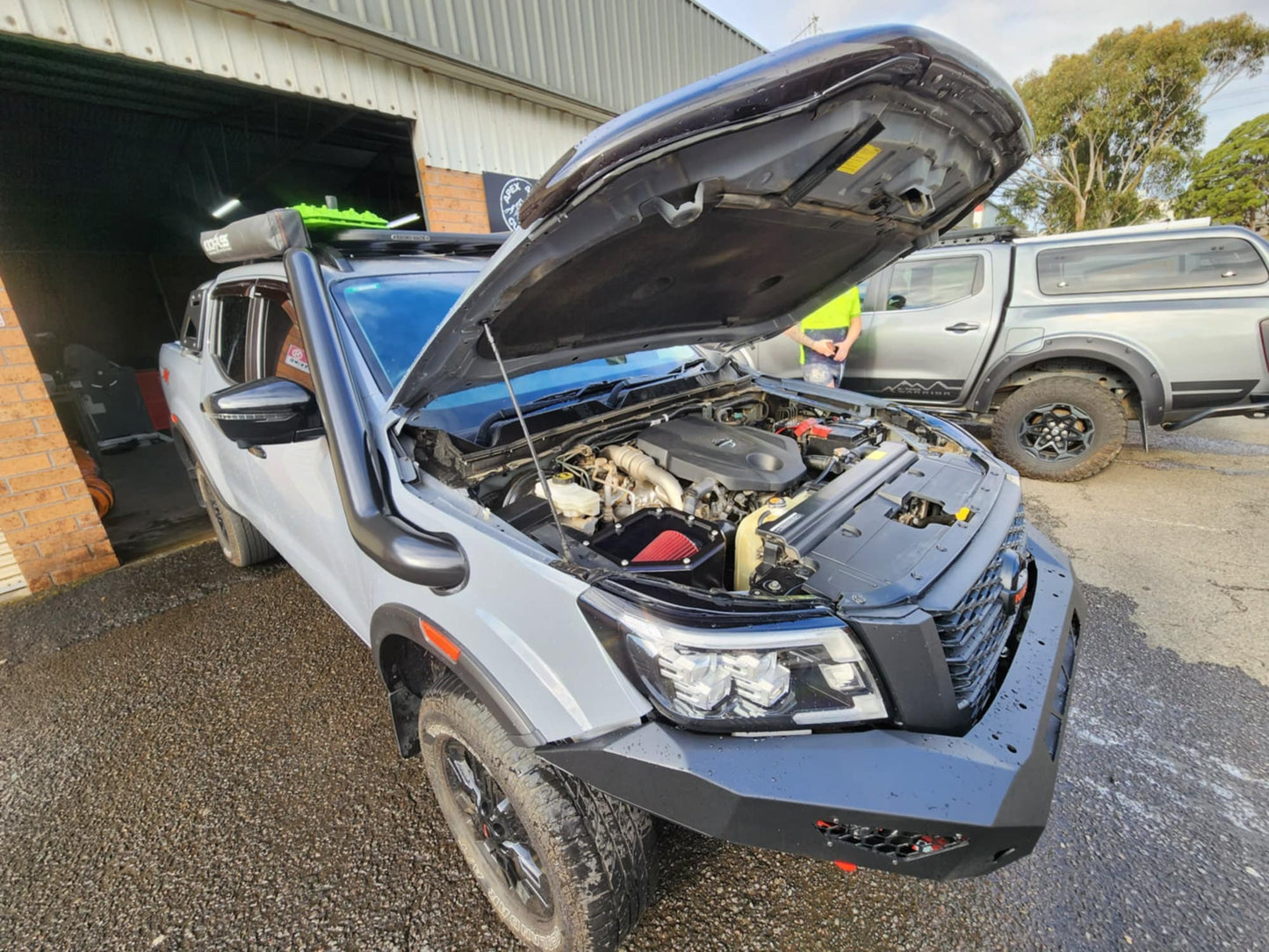 Pickup truck with open hood exposing engine
