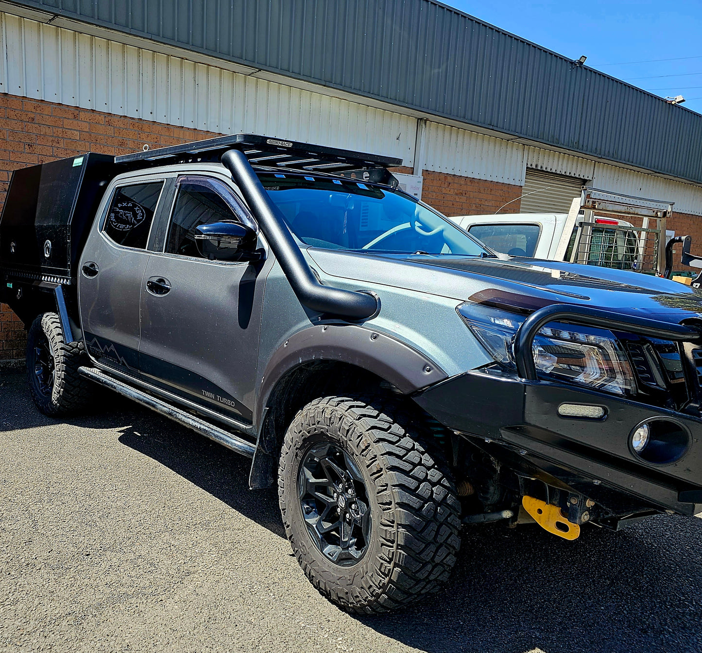 Grey pickup truck parked on a paved road